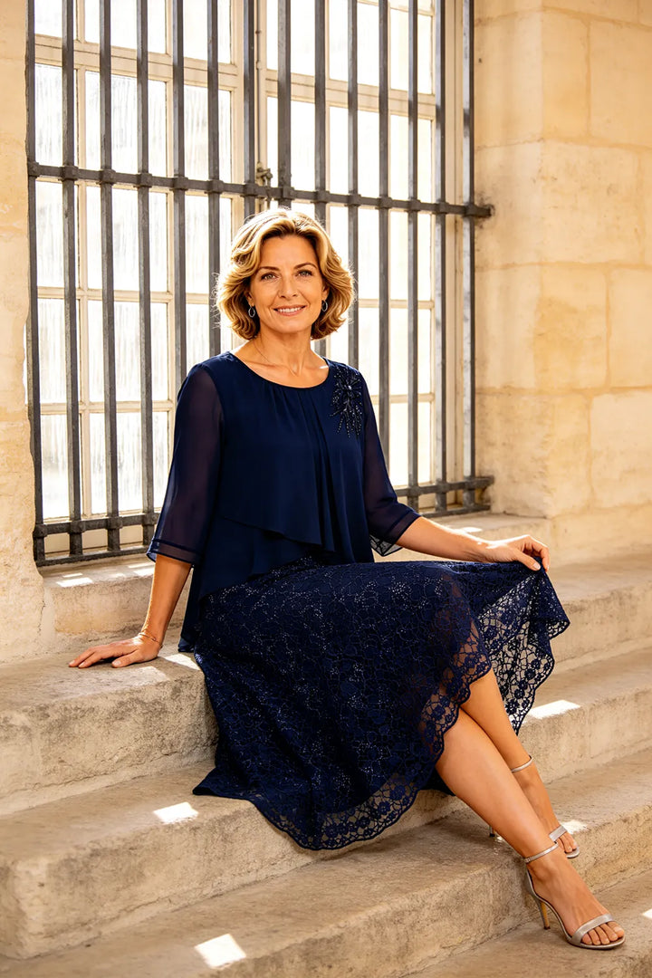 Lace mother of the bride dress in dark navy, seated